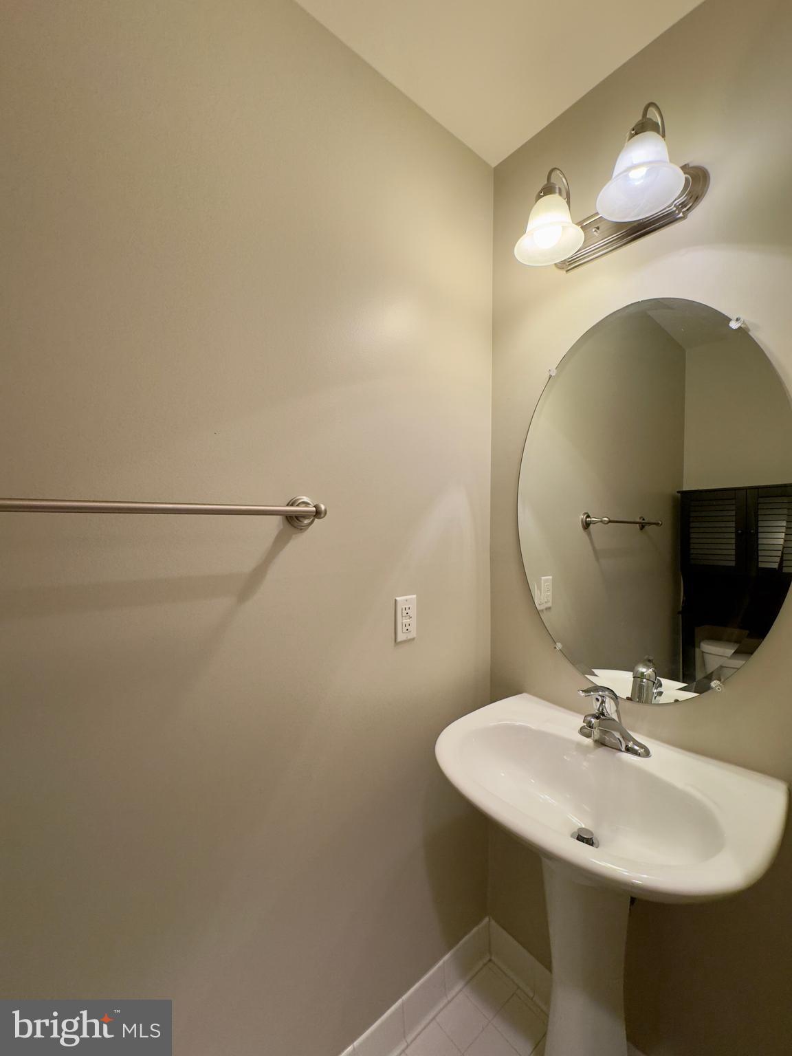 124 South Duncan Street Baltimore, MD 21231 - Photo 11 of 30 a bathroom with a sink and a mirror