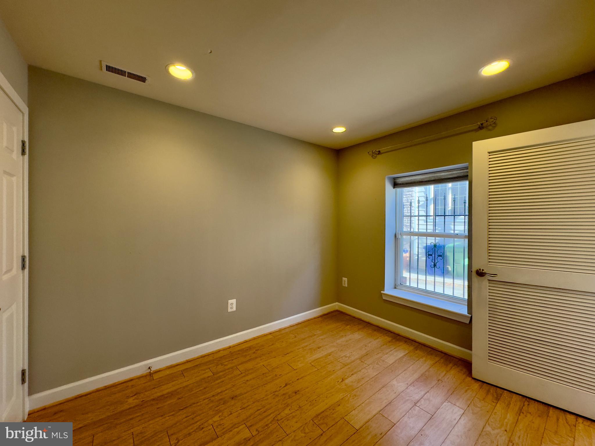 124 South Duncan Street Baltimore, MD 21231 - Photo 14 of 30 an empty room with wooden floor and windows
