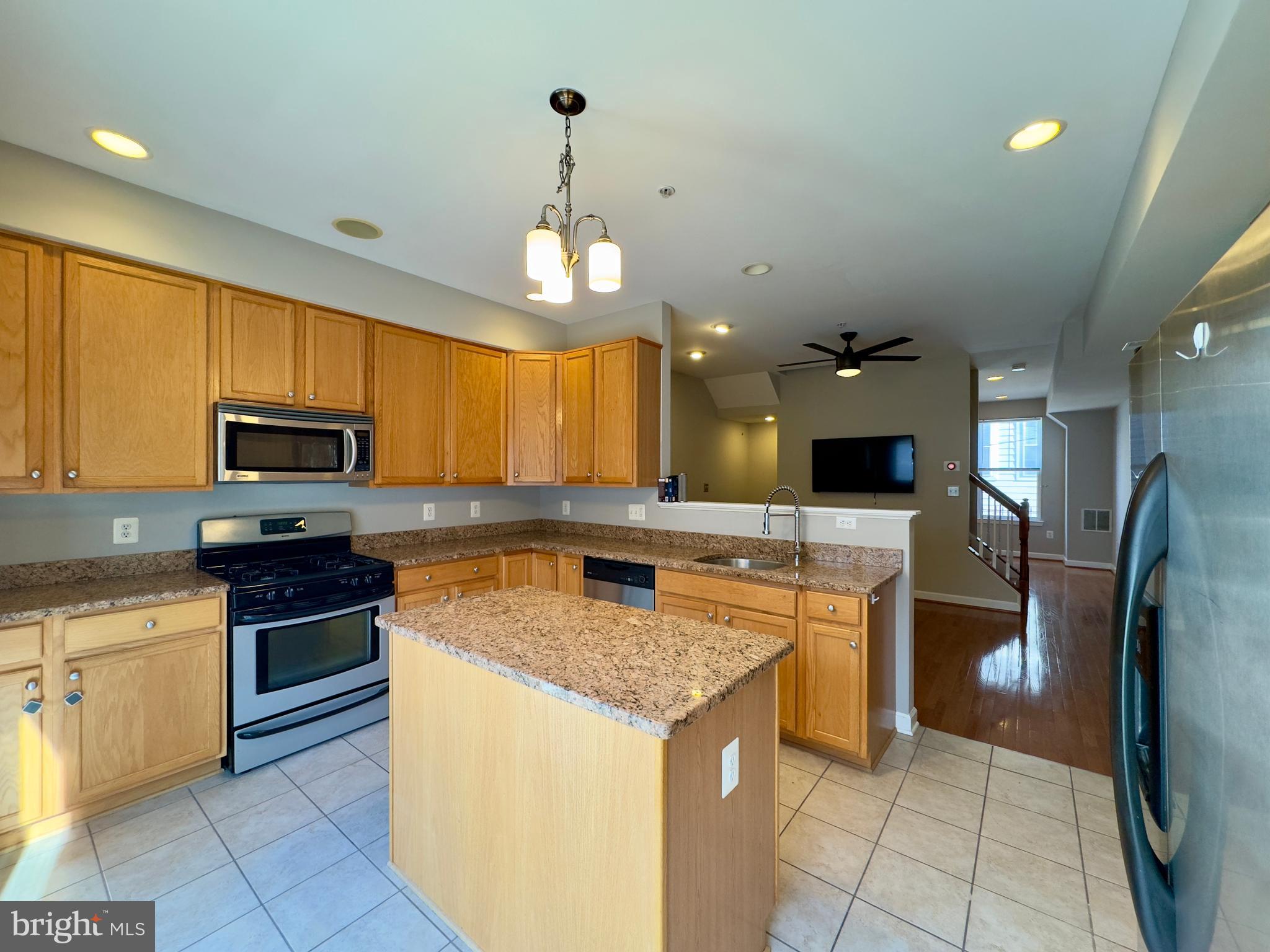 124 South Duncan Street Baltimore, MD 21231 - Photo 20 of 30 a kitchen with stainless steel appliances granite countertop a stove top oven a refrigerator a sink and dishwasher