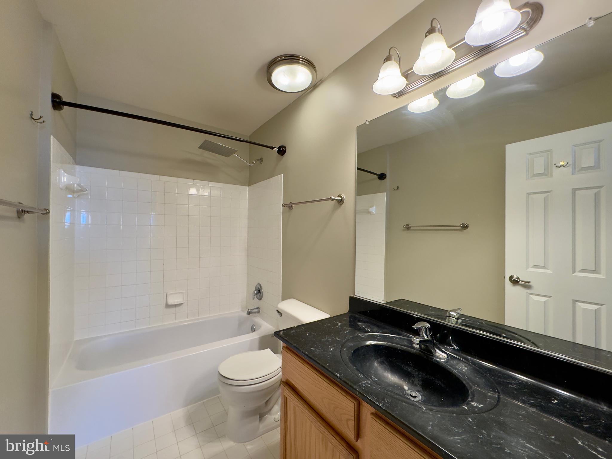 124 South Duncan Street Baltimore, MD 21231 - Photo 28 of 30 a bathroom with a sink a toilet a mirror and shower