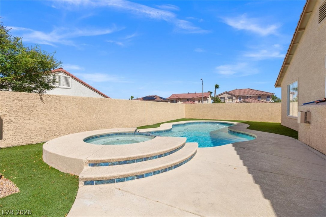 1007 Golden Ridge Court Henderson, NV 89052 - Photo 22 of 27 An inviting backyard oasis centers around a custom swimming pool and an elevated spa.