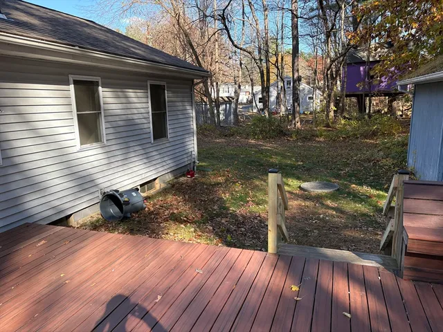 a view of a house with wooden deck