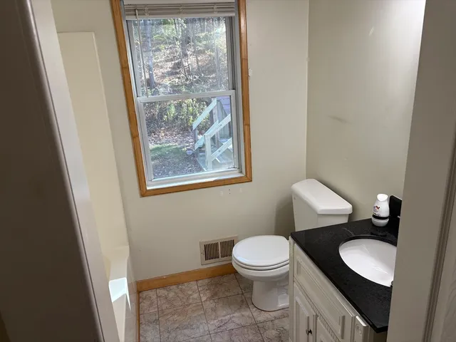 a white toilet sitting next to a bathroom sink