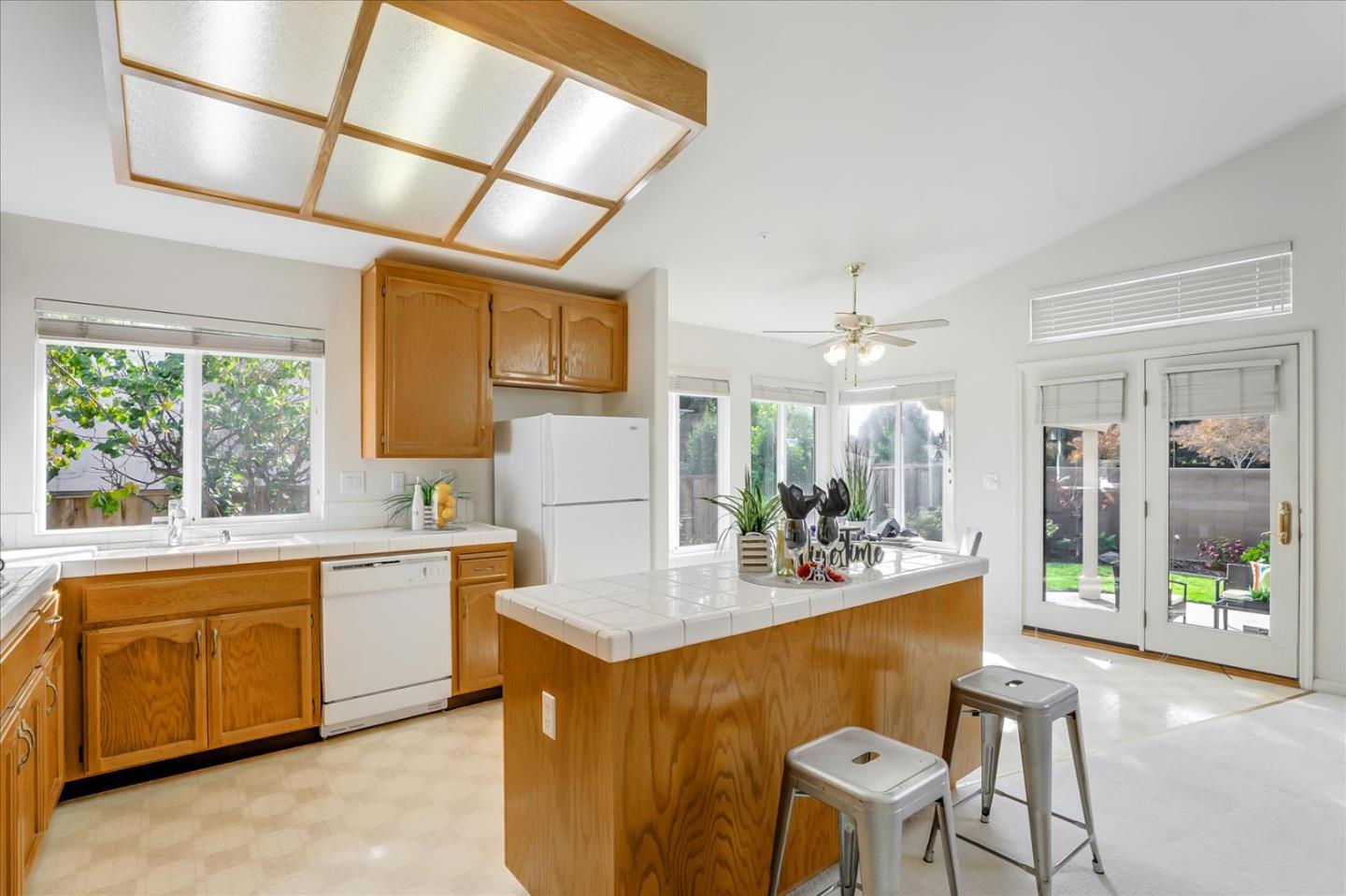 883 Marcella Street Livermore, CA 94550 - Photo 11 of 44 a dining hall with stainless steel appliances granite countertop a sink a stove a dining table and chairs with wooden floor