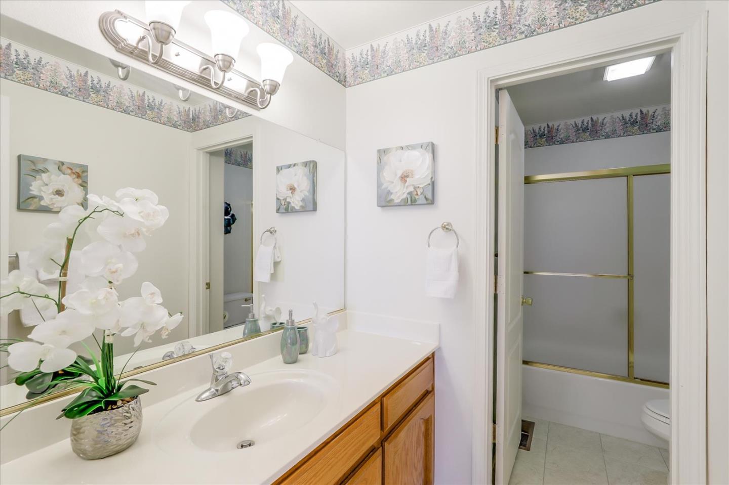 883 Marcella Street Livermore, CA 94550 - Photo 32 of 44 a bathroom with a sink a mirror and a shower