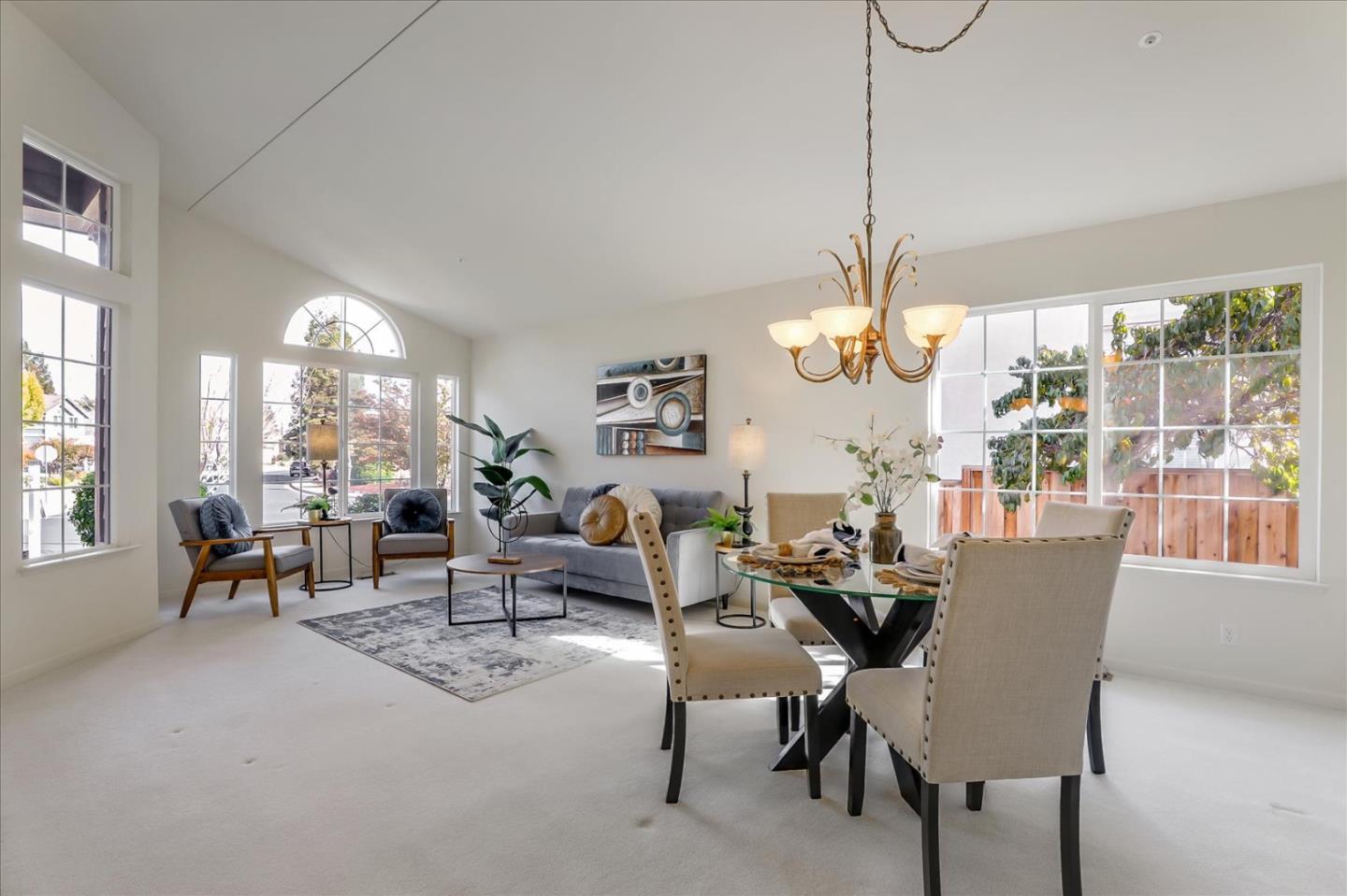 883 Marcella Street Livermore, CA 94550 - Photo 5 of 44 a dining room with furniture large windows and a chandelier
