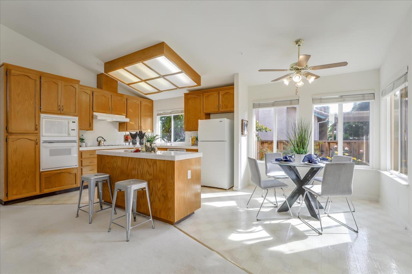 883 Marcella Street Livermore, CA 94550 - Photo 10 of 44 a dining room with stainless steel appliances a dining table wooden floor and a refrigerator
