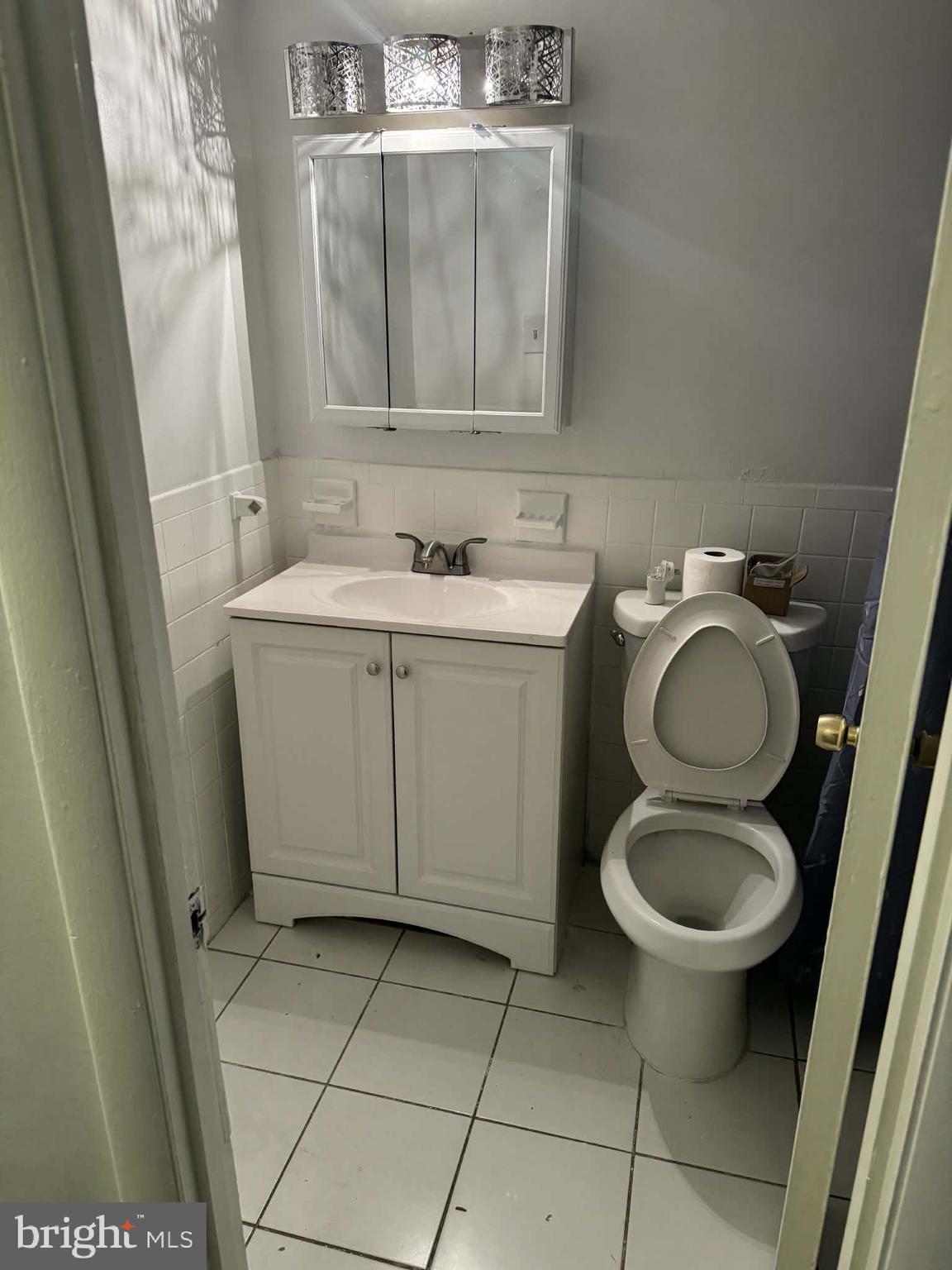 204 St Barnabas Road, Unit T Suitland, MD 20746 - Photo 8 of 10 a bathroom with a toilet sink and mirror