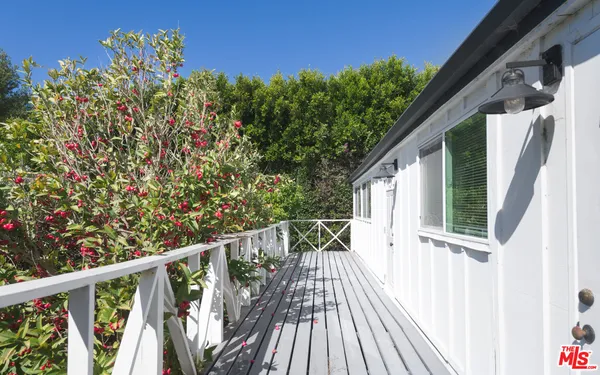 a view of balcony with wooden floor and fence