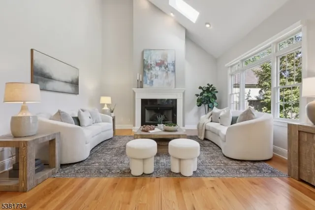 a living room with furniture a table and a fireplace
