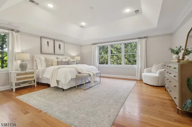 a bedroom with a bed and large window
