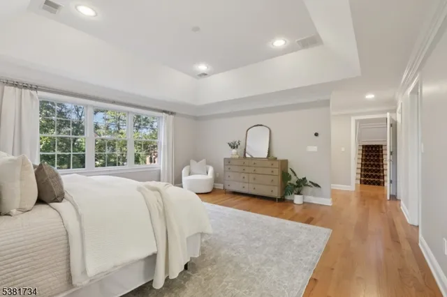 a living room with a bed furniture and a large window