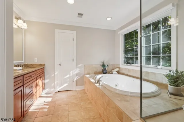 a spacious bathroom with a tub and sink