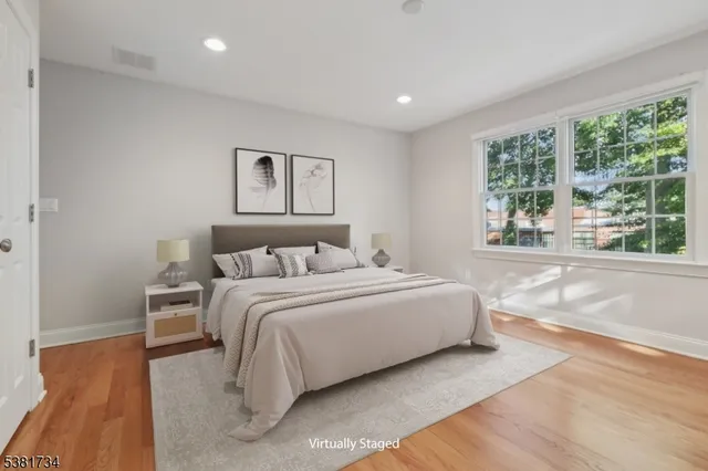 a spacious bedroom with a large bed and a large window