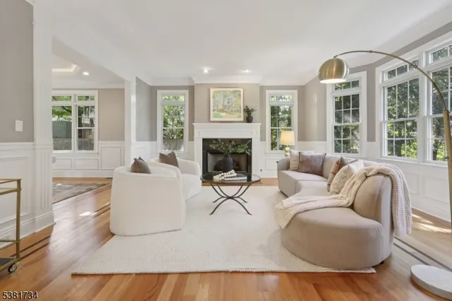 a living room with furniture fireplace and windows