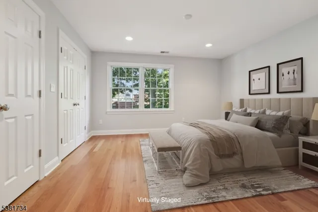 a spacious bedroom with a bed and a window