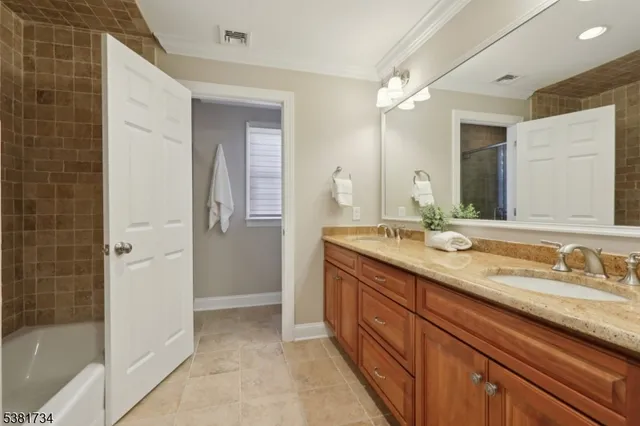 a spacious bathroom with a granite countertop sink mirror and shower