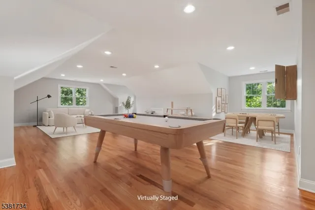 a living room with lots of furniture and a wooden floor
