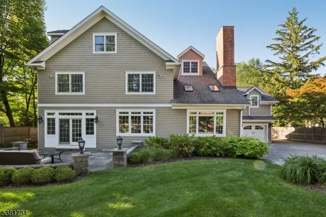 a front view of a house with a yard and potted plants