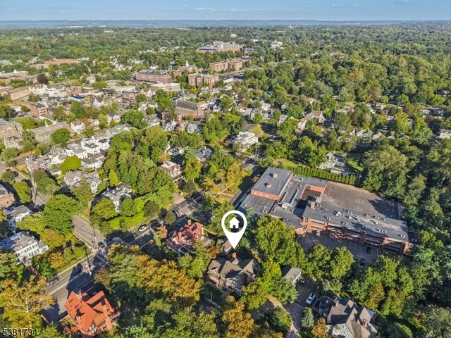 a view of a city with lush green forest