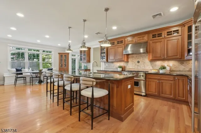 a large kitchen with lots of counter space and dining table