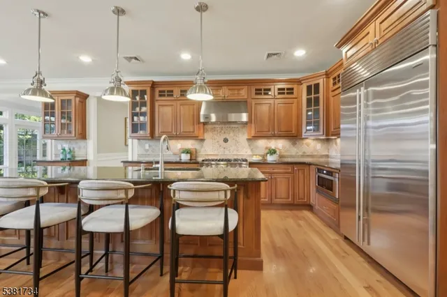 a kitchen with a table chairs refrigerator and cabinets