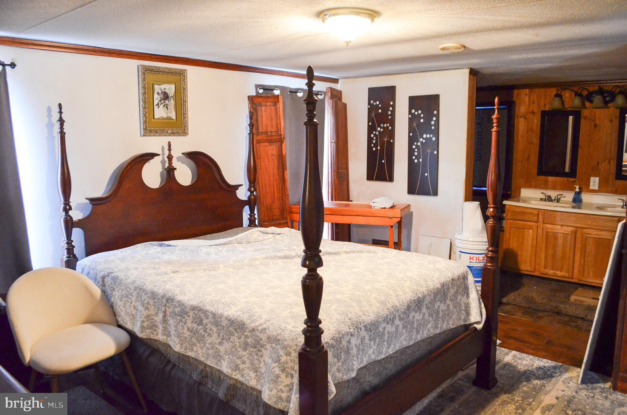 2001 Red Bank Road Dover, PA 17315 - Photo 14 of 19 a bedroom with a bed and dresser with wooden floor