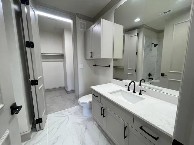 a bathroom with a double vanity sink a mirror and a bathtub