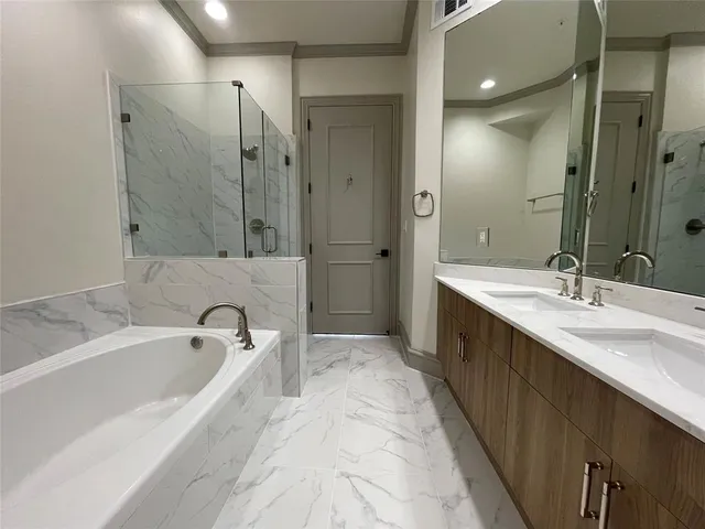 a bathroom with a tub and shower