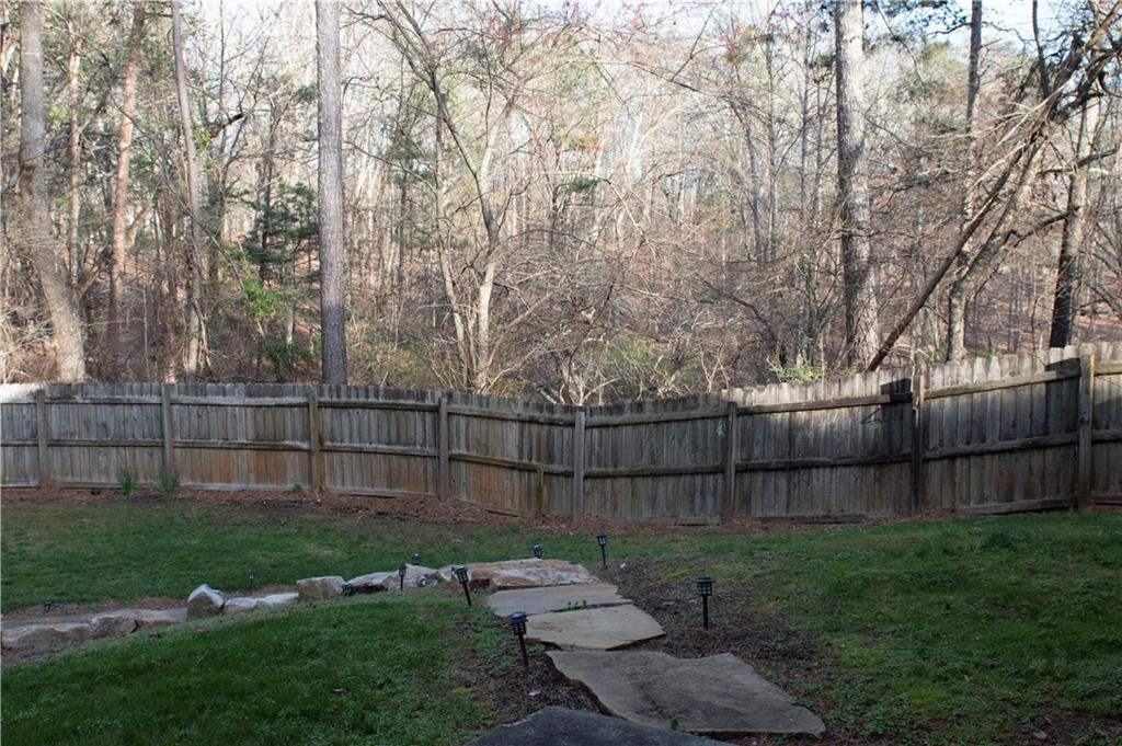 3626 Thompson Bend Gainesville, GA 30506 - Photo 11 of 14 a view of a backyard with large trees and wooden fence