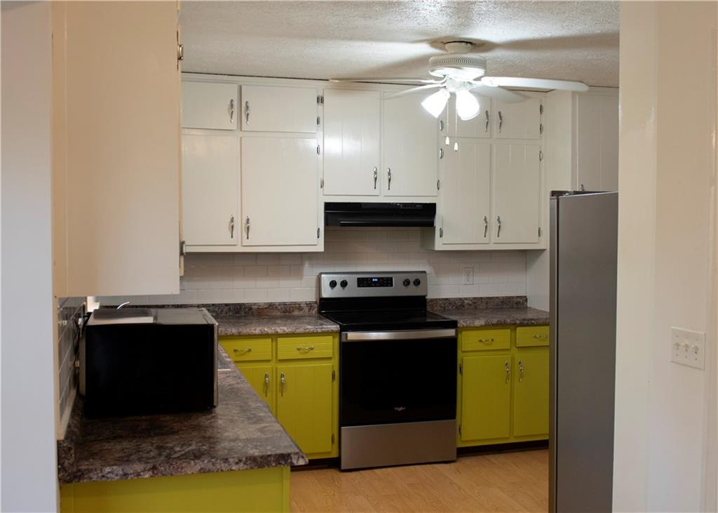 3626 Thompson Bend Gainesville, GA 30506 - Photo 6 of 14 a kitchen with stainless steel appliances granite countertop a stove a sink and a refrigerator