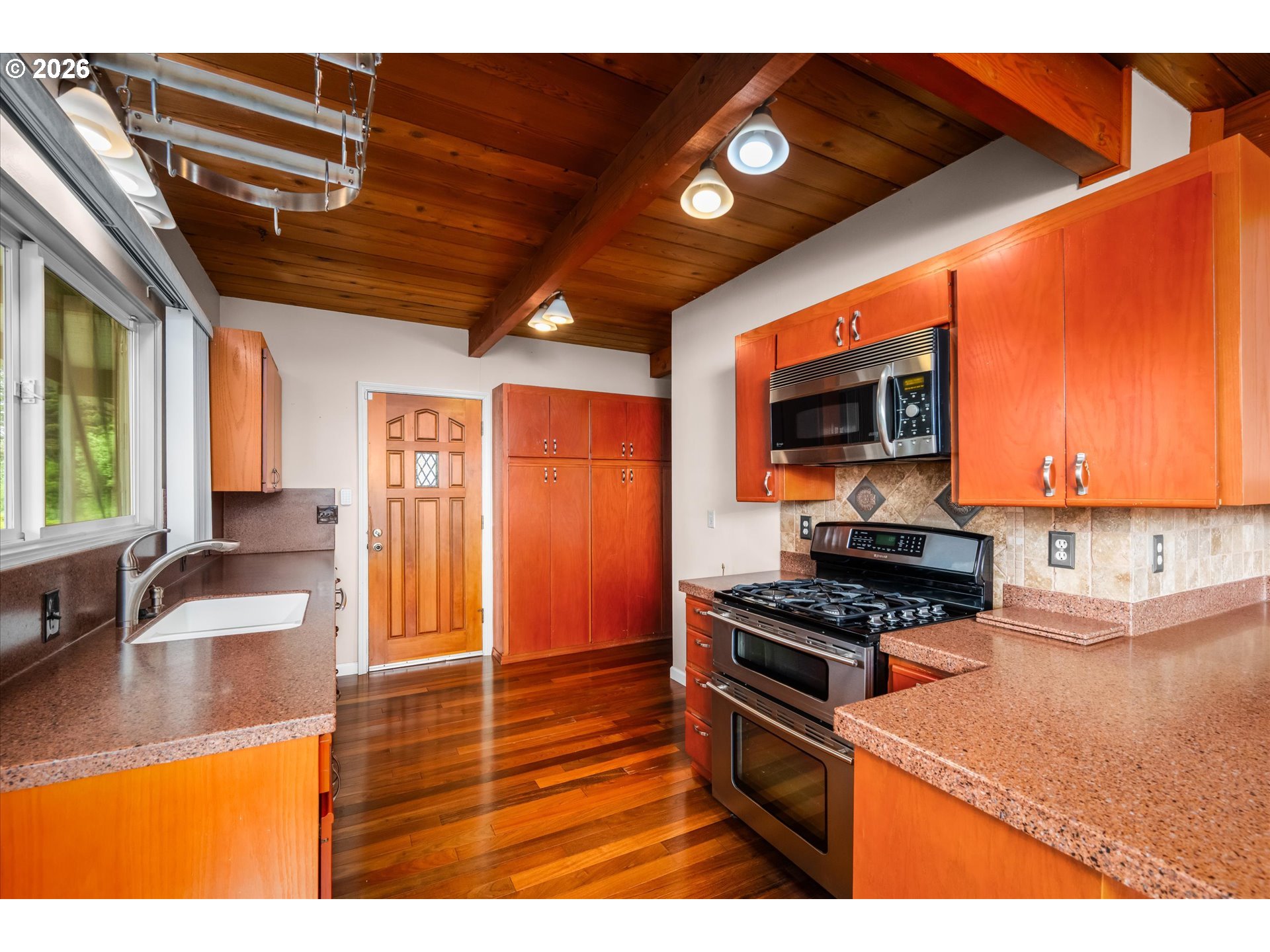 2012 Greiner Street Eugene, OR 97405 - Photo 14 of 45 a kitchen with stainless steel appliances granite countertop a stove a sink and a microwave