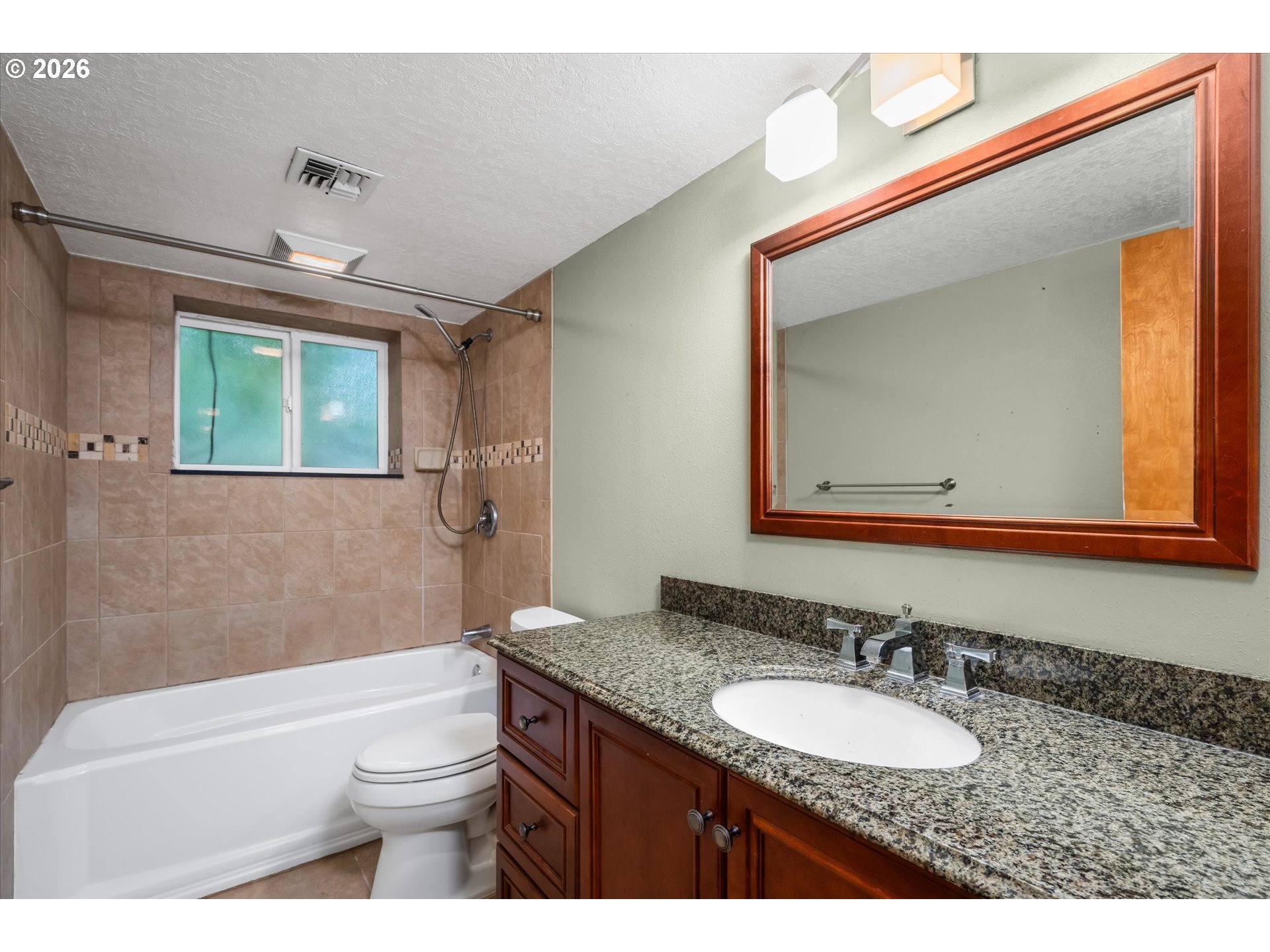 2012 Greiner Street Eugene, OR 97405 - Photo 31 of 45 a bathroom with a granite countertop sink mirror vanity bathtub and a toilet