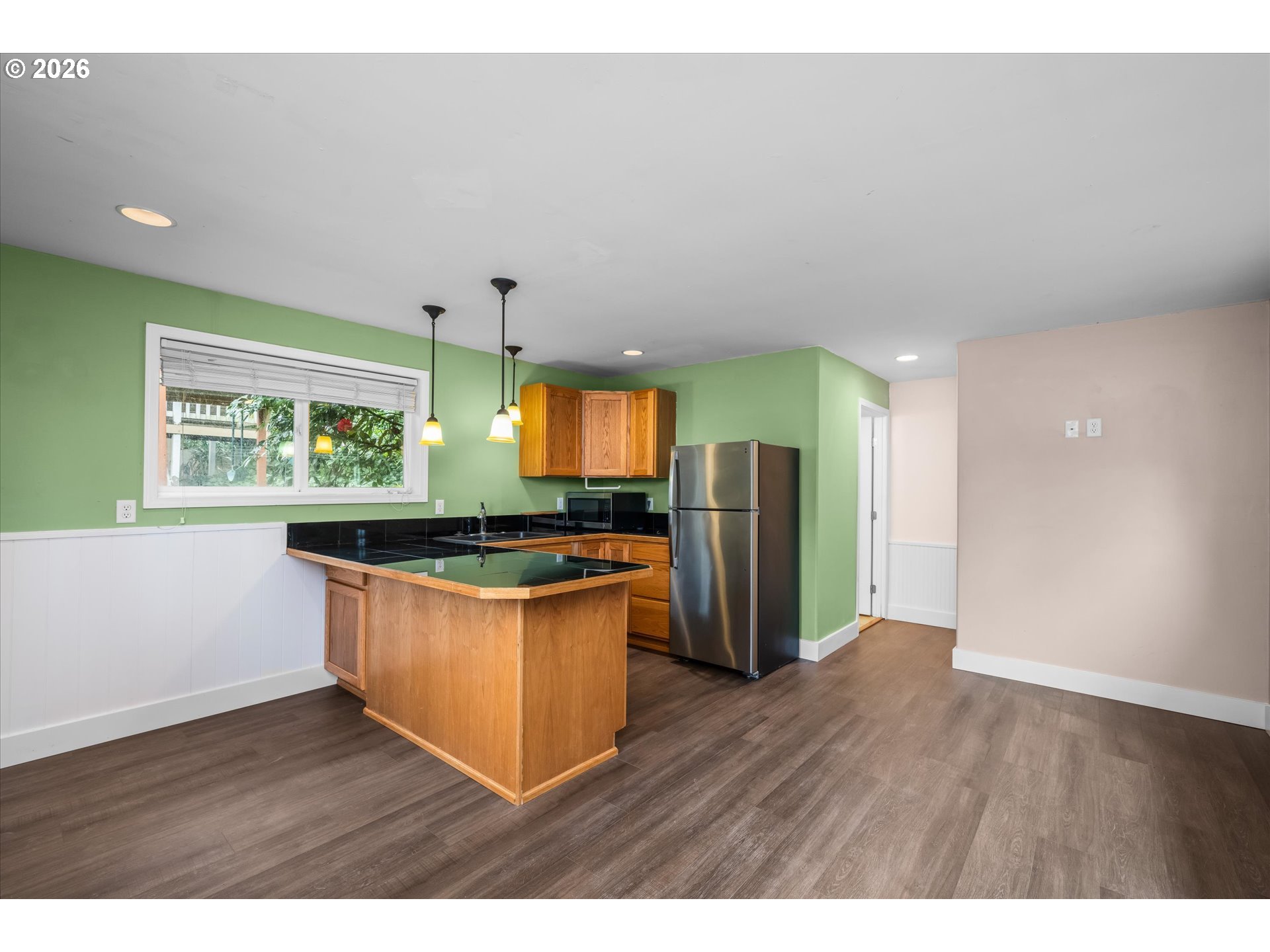 2012 Greiner Street Eugene, OR 97405 - Photo 32 of 45 a kitchen with stainless steel appliances granite countertop a stove a refrigerator a sink a oven with wooden floor