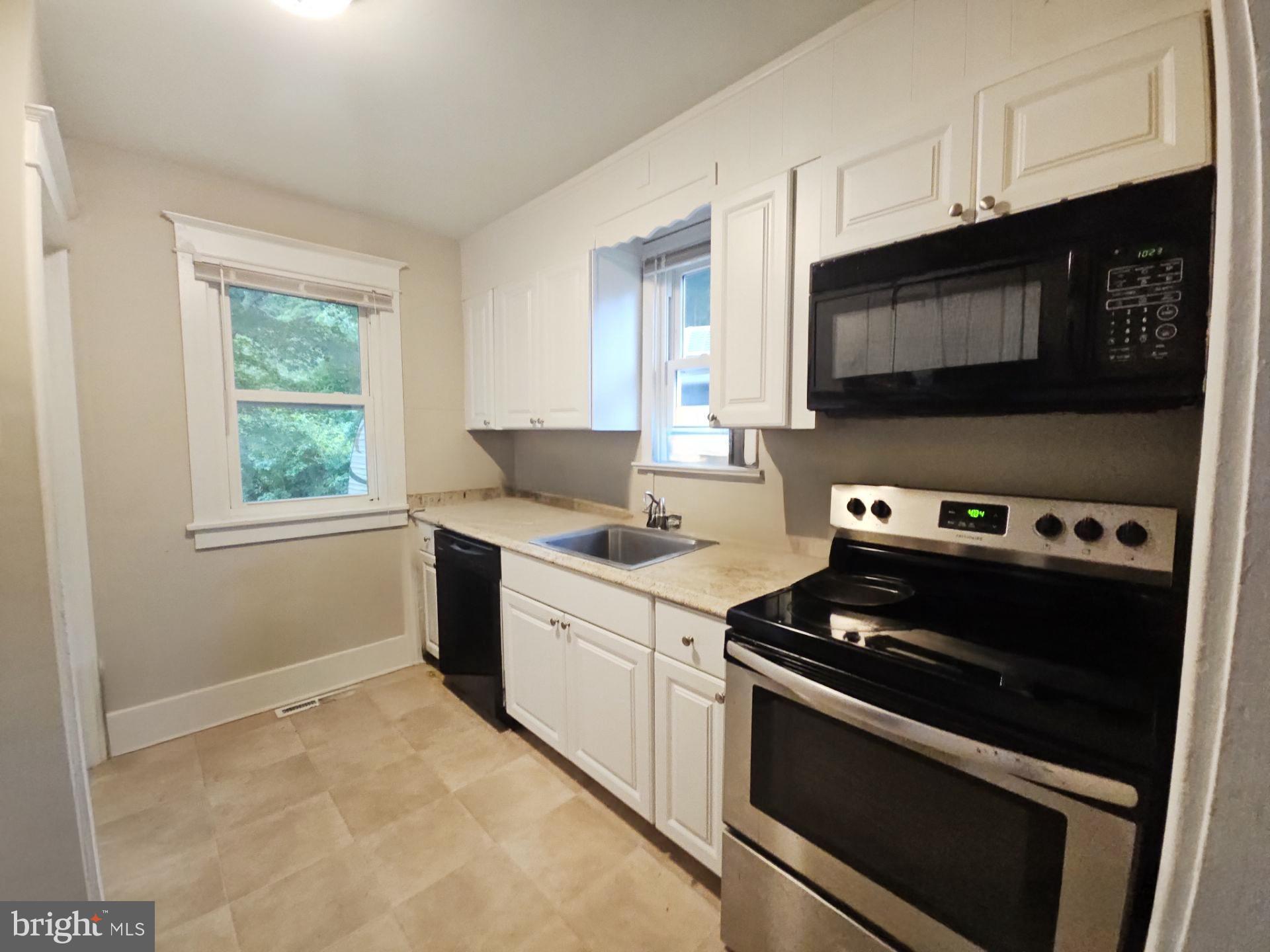 279 Logwood Avenue Carneys Point, NJ 08069 - Photo 4 of 7 a kitchen with a stove and a microwave
