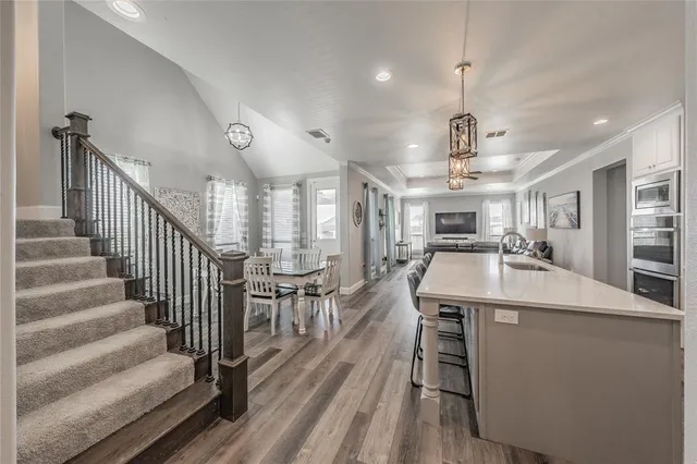 a kitchen with stainless steel appliances kitchen island a refrigerator and a stove top oven