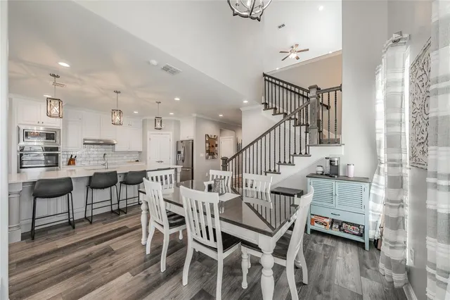 a dining room with furniture and wooden floor