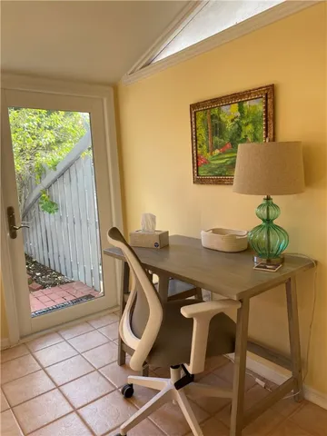 a view of a workspace with furniture and window