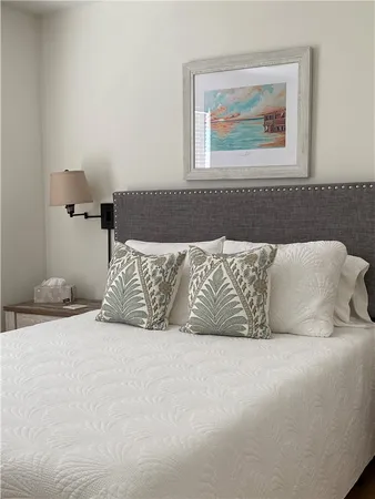 a bedroom with a bed and a mirror on dresser