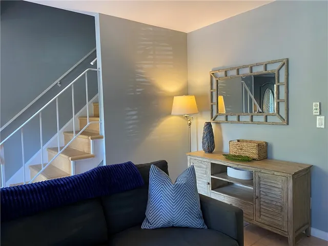 a living room with furniture and a painting on the wall