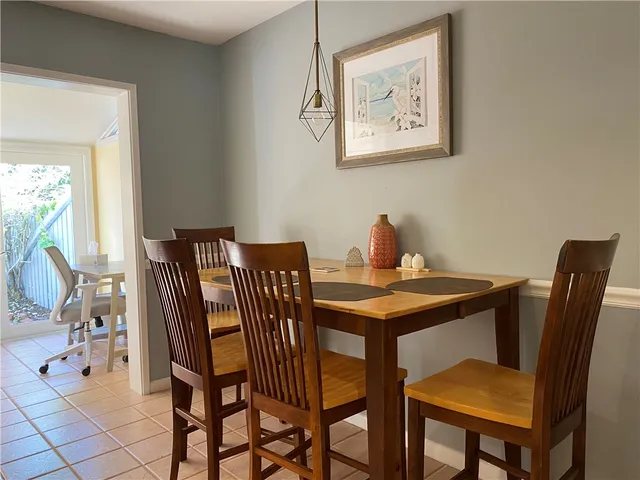 a view of a dining room with furniture and a potted plant
