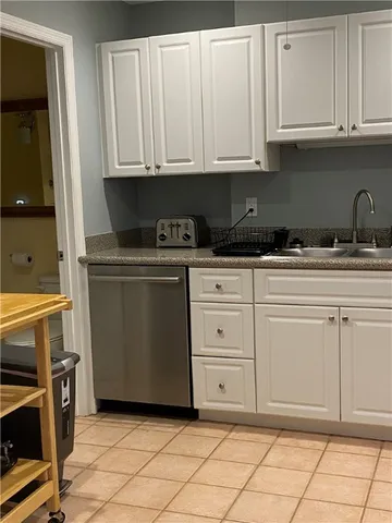 a kitchen with granite countertop white cabinets and stainless steel appliances