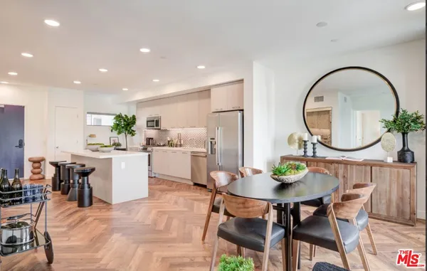 a kitchen with a dining table a stove a dining table and chairs