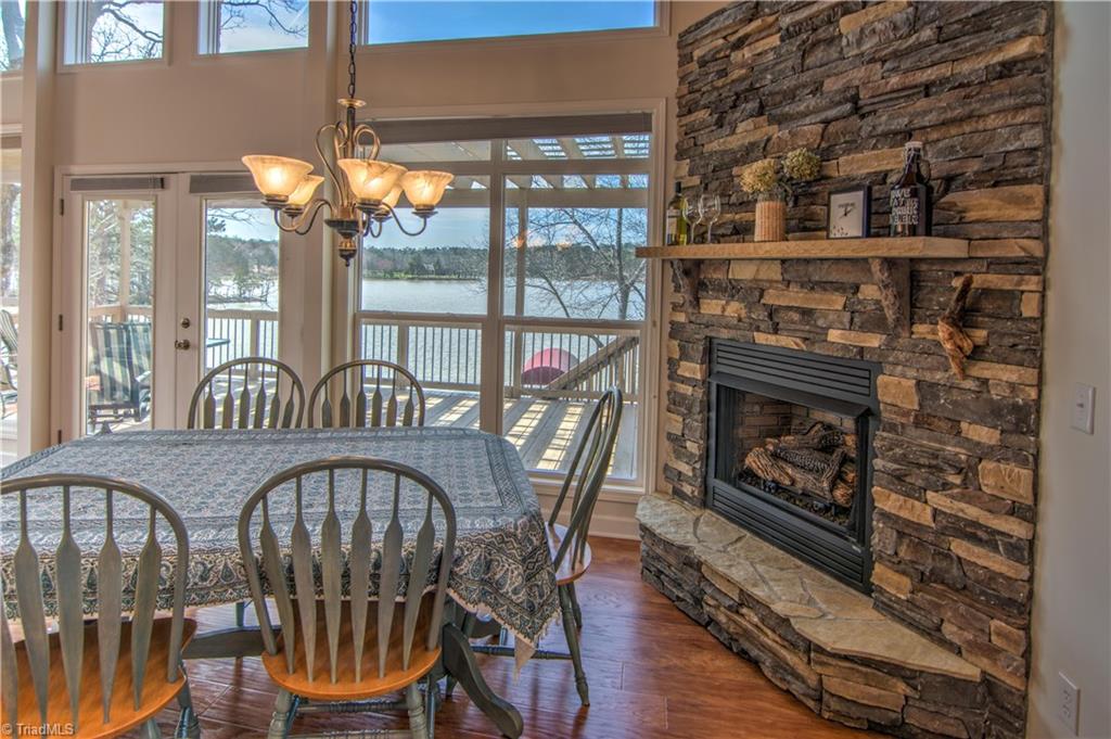 198 Shoreline Road New London, NC 28127 - Photo 13 of 28 Open kitchen with rock fireplace and amazing views of the lake.