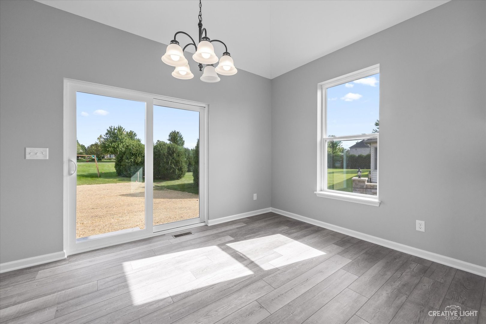 151 Quinlan Avenue DeKalb, IL 60115 - Photo 15 of 29 a view of an empty room with wooden floor and a window