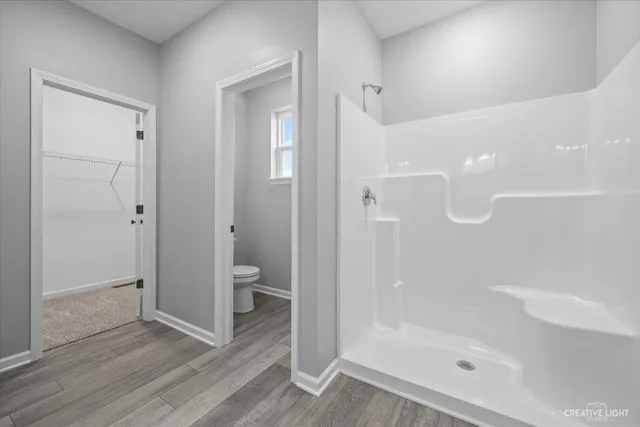 a white toilet sitting next to a bathroom