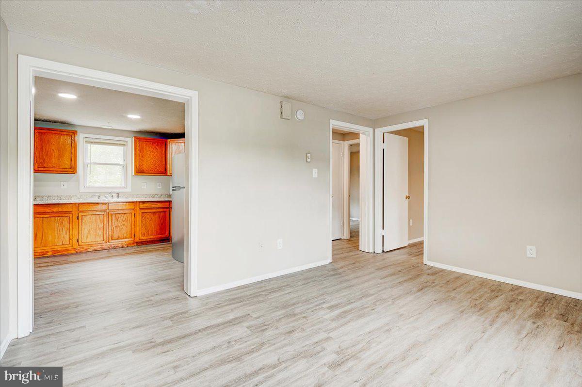 1867 Johnson Road Chambersburg, PA 17202 - Photo 4 of 16 a view of empty room with wooden floor and entryway