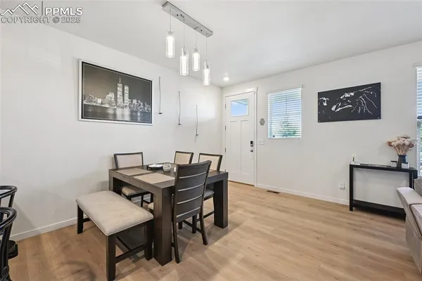 a view of a dining room with furniture and wooden floor