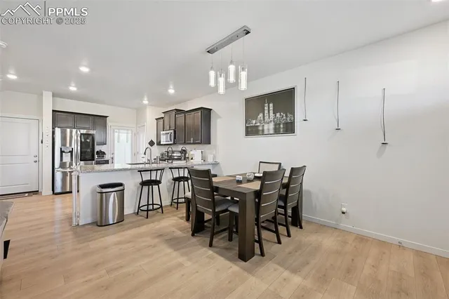 a view of kitchen with sink microwave and dining table