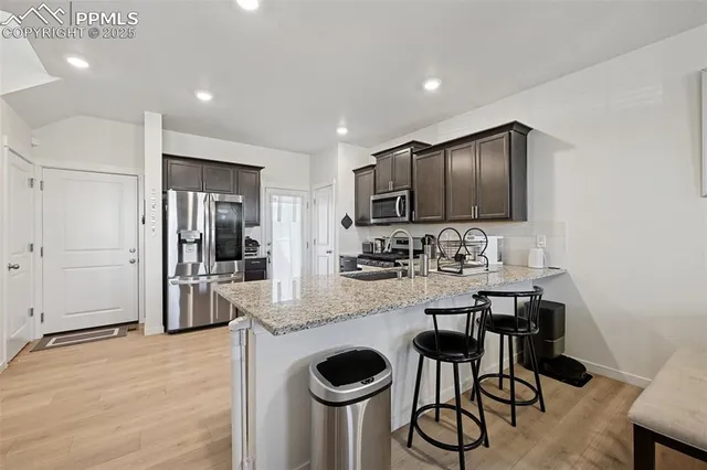 a kitchen with granite countertop cabinets and stainless steel appliances